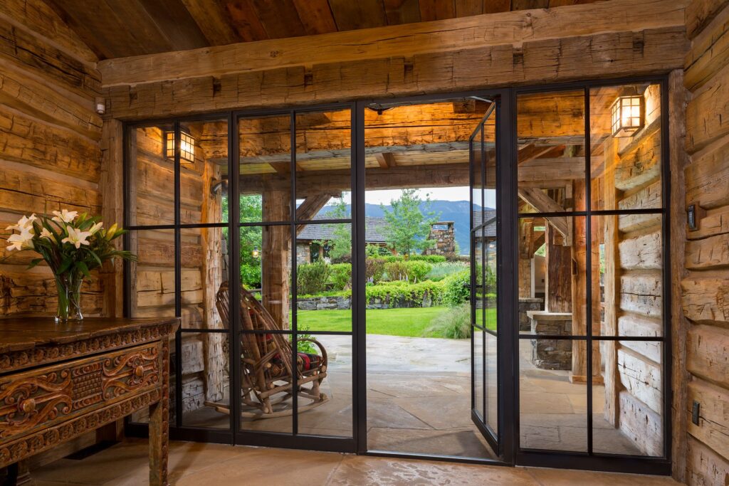 Log cabin with custom RTS-430 series steel doors and windows by Optimum Window